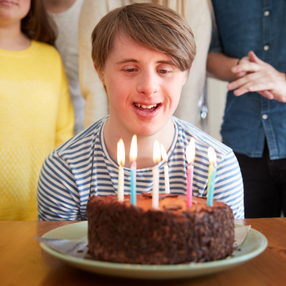 Boy blowing out birthday candles on a cake