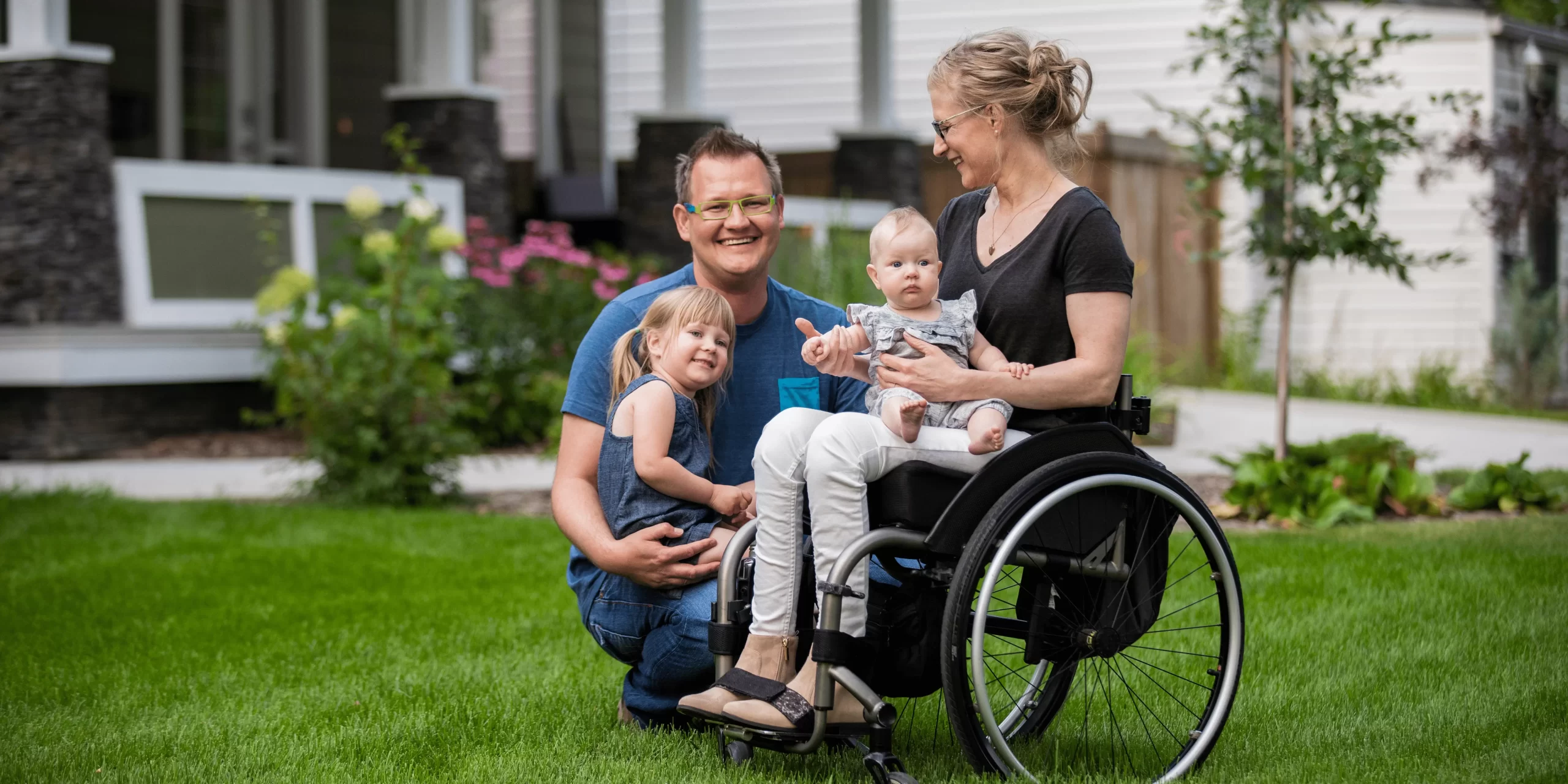 Family on lawn mum in a wheelchair