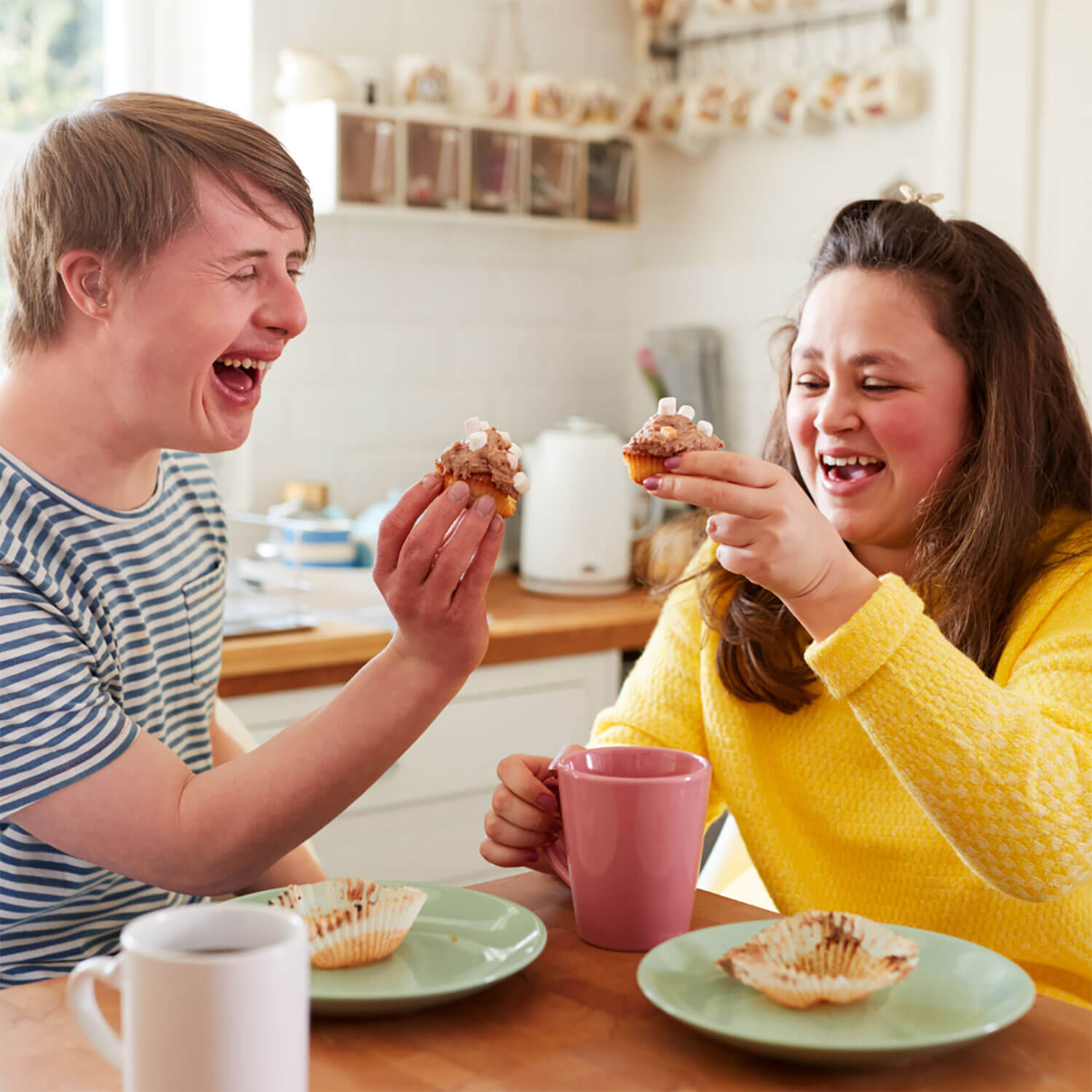 Boy and girl drinking tea and muffins