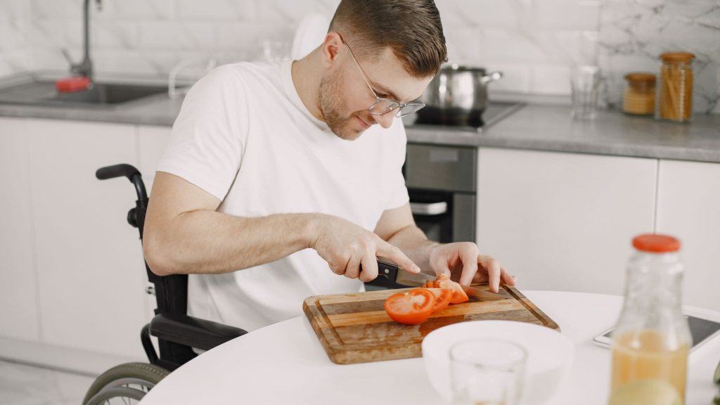 Ipswich's NDIS Rental Properties: Guy cutting tomatoes