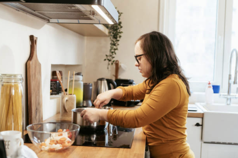 Woman with disability cooking independently in modern kitchen