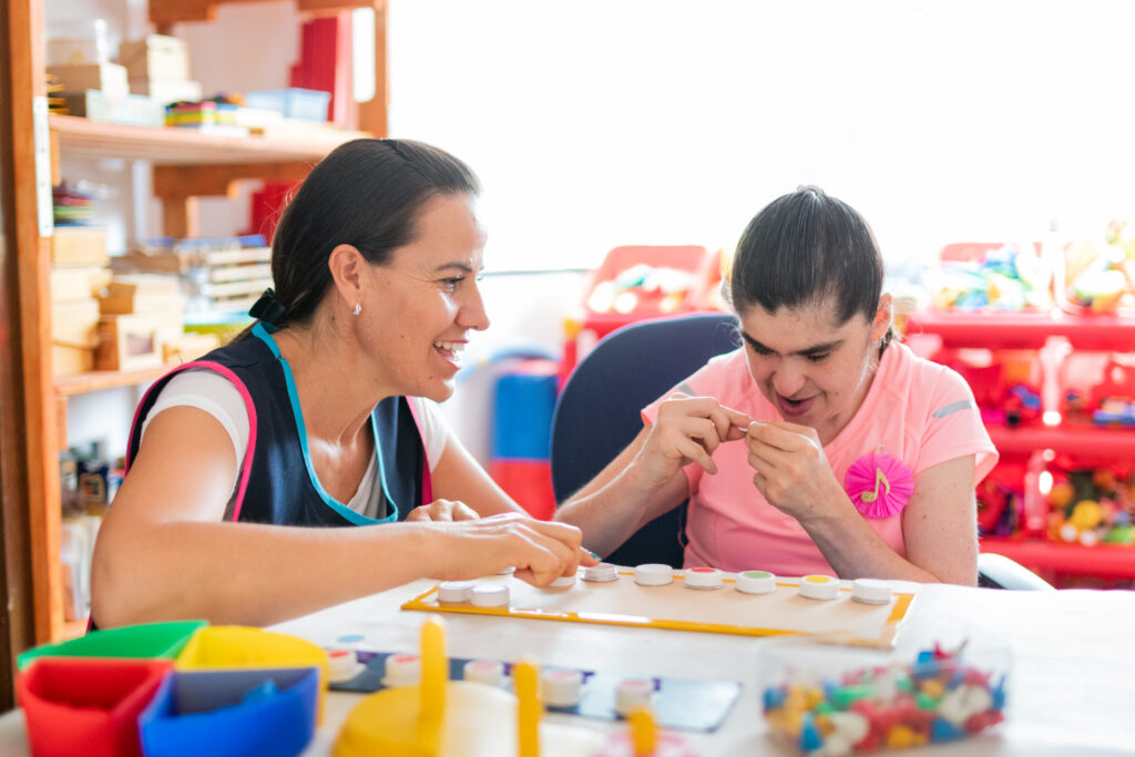 Woman supporting young participant during an engaging activity session