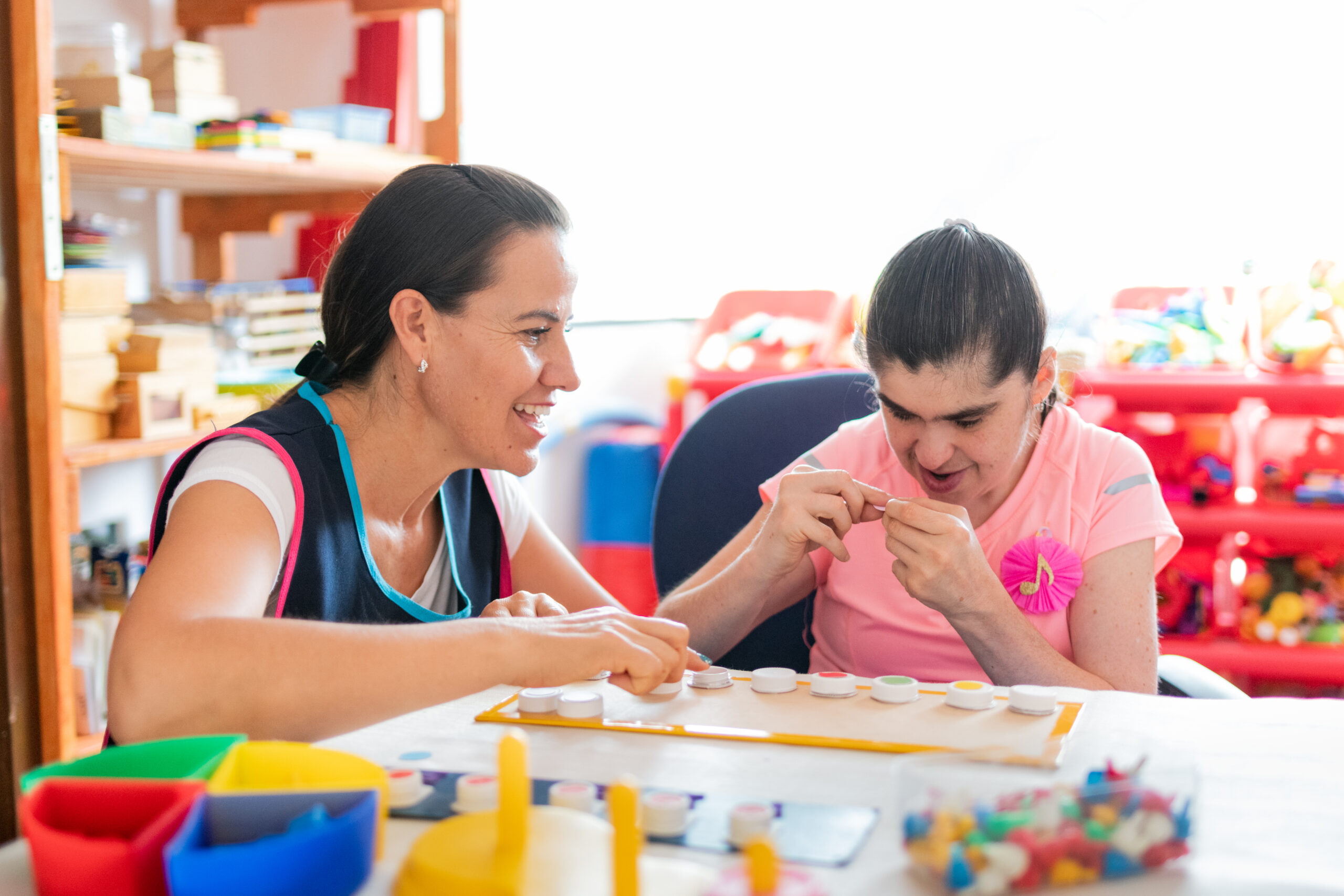 Woman supporting young participant during an engaging activity session