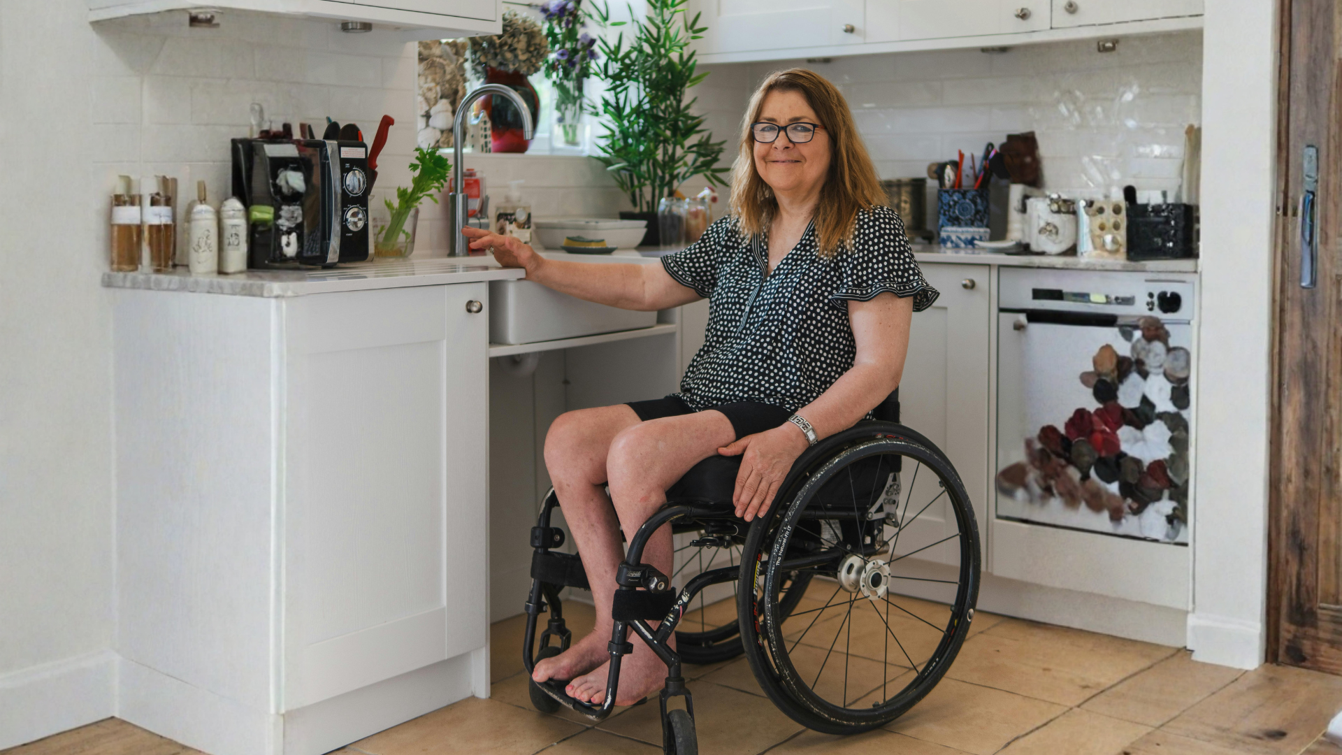 Women in wheelchair in kitchen